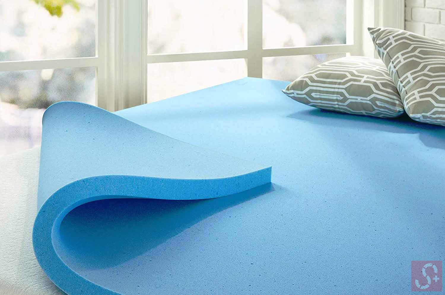 Mattress topper with two pillows inside a room